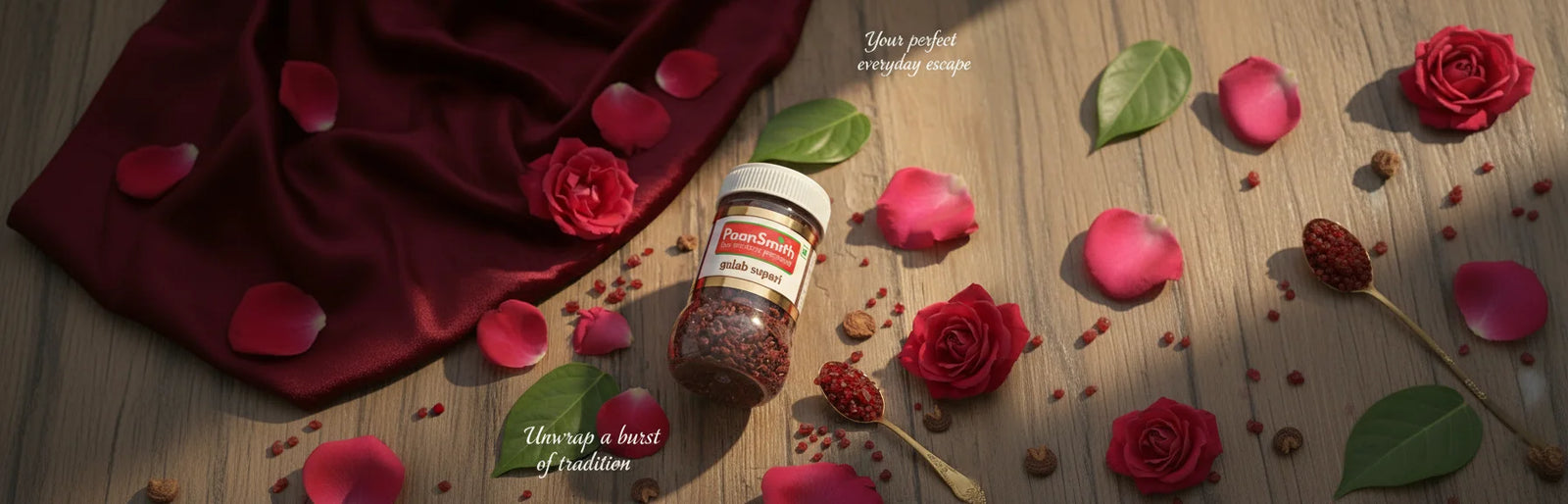 Jar of paansmith gulab supari with red rose petals on a wooden surface with scattered rose petals and leaves.